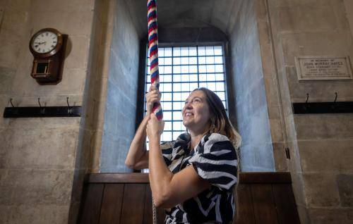 A bereaved mother rings a bell at St Paul's Cathedral in memory of her late daughter