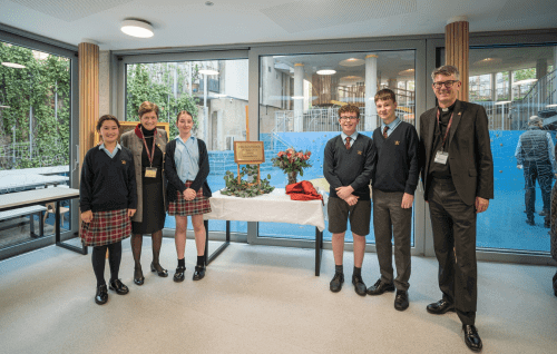Four choristers stand with the Dean and the Head of St Paul's Cathedral School at the opening of the new girls' boarding house.