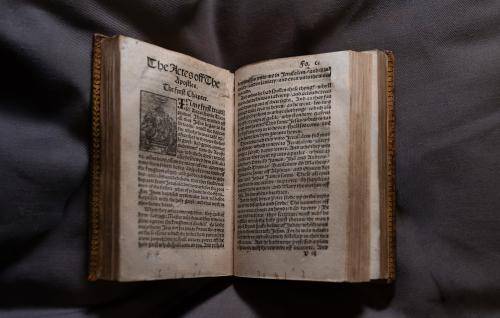 William Tyndales's new testament bible open on the first page of Acts of the Apostles