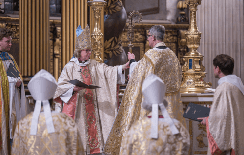 Bishop Sarah hands her crozier back to the Dean.