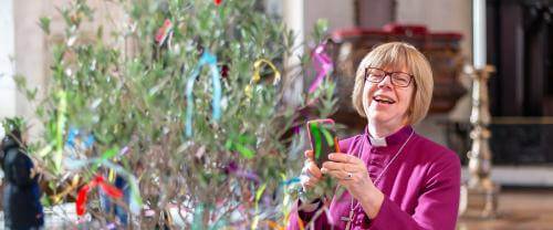bishop sarah mullally smiling with tree at messy cathedral event
