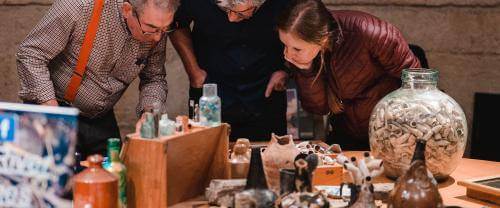 People looking at mudlarking finds.